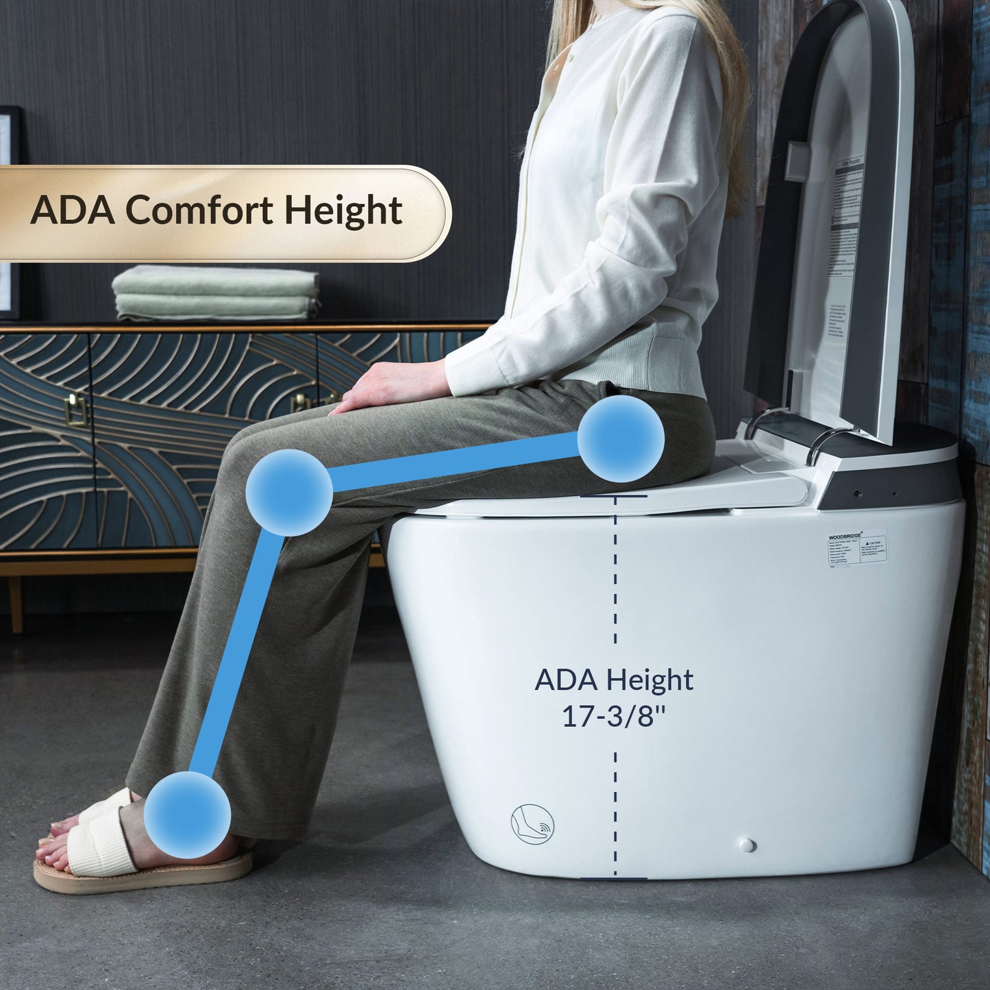 Person using a white toilet with ADA height label, sitting on a gray floor.
