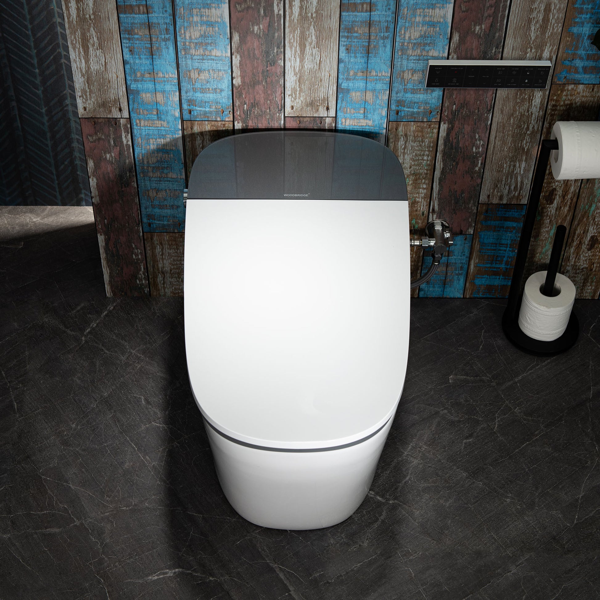 Modern toilet in a bathroom with a wooden wall and black floor.